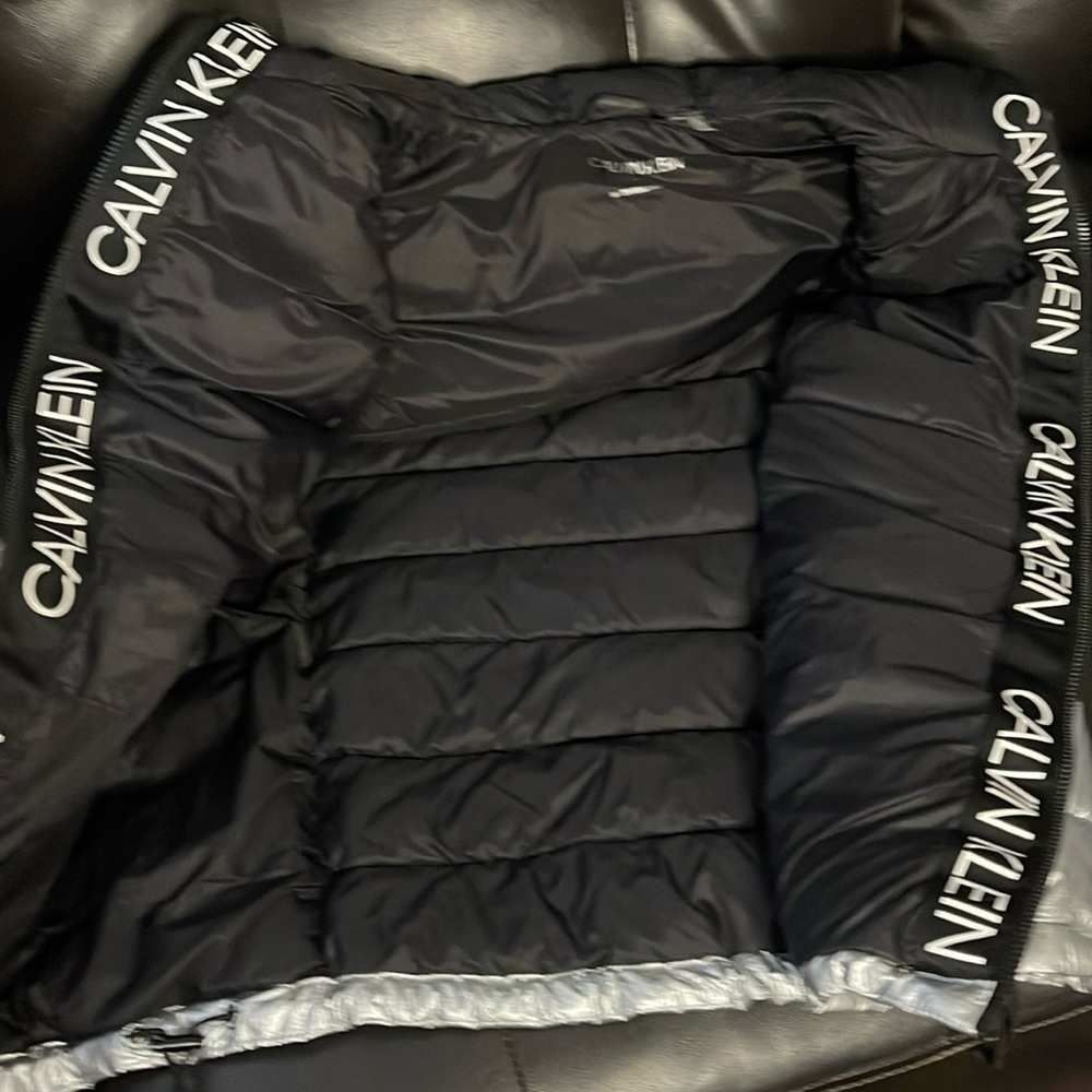 Like very brand new silver puff Calvin Klein vest